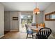Cozy dining area with a round table, bench seating, and a view of the backyard at 15837 Hidden Lake Cir, Clermont, FL 34711