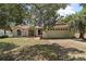 Charming single-story home with a well-manicured lawn, mature trees, and attached two-car garage at 15837 Hidden Lake Cir, Clermont, FL 34711