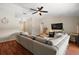 Open concept living room featuring stylish furniture, vaulted ceilings, and modern ceiling fan at 15837 Hidden Lake Cir, Clermont, FL 34711