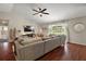 Bright living room with dark hardwood floors and comfortable sectional sofa at 15837 Hidden Lake Cir, Clermont, FL 34711