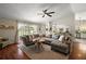 Spacious living room with a large sectional sofa and view into the kitchen at 15837 Hidden Lake Cir, Clermont, FL 34711