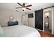 Stylish bedroom with dark wood floors, modern barn door, and ensuite bathroom at 15837 Hidden Lake Cir, Clermont, FL 34711