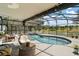 Relaxing screened-in pool area offering a serene view of the lush golf course at 15837 Hidden Lake Cir, Clermont, FL 34711