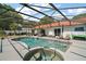 Inviting screened-in pool area featuring a built-in hot tub and ample space for relaxation at 15837 Hidden Lake Cir, Clermont, FL 34711
