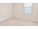 Neutral bedroom with a window and plush carpeting at 17112 Goldcrest Loop, Clermont, FL 34714