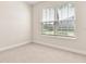 Neutral bedroom with carpeting, a window with a view and natural light at 17112 Goldcrest Loop, Clermont, FL 34714