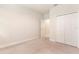 Carpeted bedroom with closet, adjacent bathroom and neutral wall color at 17112 Goldcrest Loop, Clermont, FL 34714
