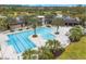 Aerial view of a resort-style pool with palm trees and ample seating for residents and guests at 17112 Goldcrest Loop, Clermont, FL 34714