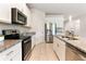 Spacious kitchen with granite countertops, stainless steel appliances, and ample cabinet space at 17112 Goldcrest Loop, Clermont, FL 34714
