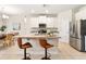 Well-equipped kitchen featuring stainless steel appliances, granite counters, and seating at the island at 17112 Goldcrest Loop, Clermont, FL 34714