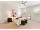 Spacious main bedroom with a ceiling fan, art, and comfortable seating at 17112 Goldcrest Loop, Clermont, FL 34714