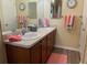 Well-lit bathroom with double sinks and updated fixtures, adding to its appeal at 1723 Banberry Run, The Villages, FL 32162