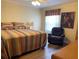 Bedroom with a ceiling fan, and a chair near the window, creating a relaxing atmosphere at 1723 Banberry Run, The Villages, FL 32162