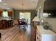 Open dining area with wood floors and sliding doors for natural light at 1723 Banberry Run, The Villages, FL 32162