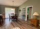 Cozy dining area with stylish lighting fixture and wood flooring at 1723 Banberry Run, The Villages, FL 32162