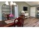 Cozy dining room featuring a wooden table, lovely decor, and an open floor plan at 1723 Banberry Run, The Villages, FL 32162