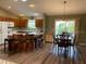 Open kitchen flows into dining area, with island and stainless appliances at 1723 Banberry Run, The Villages, FL 32162
