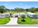 Aerial view of a cozy home featuring a well-manicured lawn and convenient golf course access at 1726 W Schwartz Blvd, Lady Lake, FL 32159
