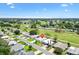 Wide aerial view of home and community featuring green golf course at 1726 W Schwartz Blvd, Lady Lake, FL 32159