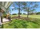 Open backyard featuring well maintained lawn, grill, and beautiful golf course view at 1726 W Schwartz Blvd, Lady Lake, FL 32159