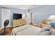 Comfortable bedroom with hardwood floors, a fan, and dresser with television at 1726 W Schwartz Blvd, Lady Lake, FL 32159