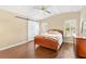 Comfortable bedroom with a sliding barn door and two windows, hardwood floors at 1726 W Schwartz Blvd, Lady Lake, FL 32159
