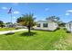 A charming single-story home with a well-kept lawn and mature palm tree in a serene community at 1726 W Schwartz Blvd, Lady Lake, FL 32159