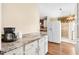 Bright kitchen featuring laminate countertops, white cabinets, and a view into the backyard at 1726 W Schwartz Blvd, Lady Lake, FL 32159