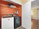 Convenient laundry room with washer, dryer, and shelving at 1726 W Schwartz Blvd, Lady Lake, FL 32159