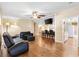 Spacious living room with hardwood floors, ceiling fan, and view into kitchen at 1726 W Schwartz Blvd, Lady Lake, FL 32159
