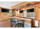 Enjoy outdoor living on this porch with a bar and three TVs at 1726 W Schwartz Blvd, Lady Lake, FL 32159