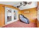 Cozy sunroom with wood paneling, three ceiling fans, and serene views of the neighborhood at 1726 W Schwartz Blvd, Lady Lake, FL 32159