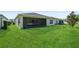 Spacious green backyard featuring a screened lanai, ideal for outdoor relaxation and entertaining at 185 Hamlet Loop, Davenport, FL 33837