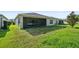 Lush green backyard with a screened-in lanai offers a perfect space for relaxation and outdoor enjoyment at 185 Hamlet Loop, Davenport, FL 33837