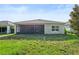 Expansive backyard featuring lush green lawn, ideal for outdoor activities and relaxation at 185 Hamlet Loop, Davenport, FL 33837