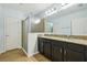 Bathroom featuring dual sinks, granite countertops, a walk-in shower, and a neutral color scheme at 185 Hamlet Loop, Davenport, FL 33837