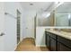 Bathroom with a walk-in shower, granite countertops, and neutral tiles at 185 Hamlet Loop, Davenport, FL 33837
