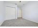 Bedroom features a closet and neutral-toned walls and carpet at 185 Hamlet Loop, Davenport, FL 33837