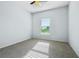 Carpeted bedroom with a ceiling fan, a large window with blinds, and lots of natural light at 185 Hamlet Loop, Davenport, FL 33837