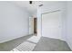 Bright bedroom features a closet and neutral-toned walls and carpet at 185 Hamlet Loop, Davenport, FL 33837