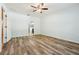 Carpeted bedroom with a ceiling fan and a large window offering a glimpse of the backyard at 185 Hamlet Loop, Davenport, FL 33837