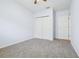 Bedroom features a closet and neutral-toned walls and carpet at 185 Hamlet Loop, Davenport, FL 33837