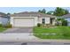 Charming single-story home with a two-car garage and well-maintained front lawn at 185 Hamlet Loop, Davenport, FL 33837