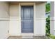 Close-up of the front door showing the entrance, door features, and welcome mat at 185 Hamlet Loop, Davenport, FL 33837
