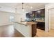 Close up of the kitchen with granite countertops, stainless appliances, and center island at 185 Hamlet Loop, Davenport, FL 33837