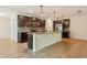 Modern kitchen with granite countertops, stainless steel appliances, and center island at 185 Hamlet Loop, Davenport, FL 33837