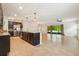 Open kitchen with a large island, stainless steel appliances, and tile flooring at 185 Hamlet Loop, Davenport, FL 33837