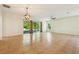 Bright living room with tile flooring, ceiling fan, and sliding glass door access to patio at 185 Hamlet Loop, Davenport, FL 33837