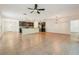 Bright, open-concept living space with tile floors, pendant lighting, and kitchen view at 185 Hamlet Loop, Davenport, FL 33837