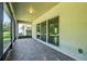 Covered patio with brick flooring and screen enclosure overlooks the backyard at 185 Hamlet Loop, Davenport, FL 33837